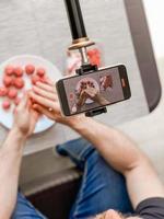 Man preparing meatballs recording video smartphone photo