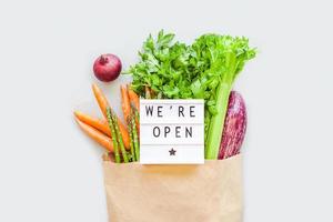 Fresh organic vegetables in craft shopping bag photo