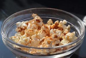 Close up on spiced popcorn in a glas bowl. photo