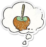 cartoon toffee apple and thought bubble as a distressed worn sticker vector