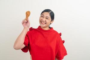 Asian woman with fried chicken on hand photo