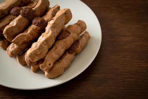 chocolate meringue stick on plate photo