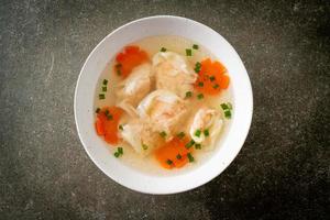 shrimp dumpling soup in white bowl photo