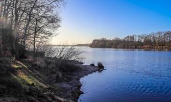 Beautiful landscape at a lake with a reflective water surface photo