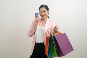 Asian woman holding shopping bag and credit card photo