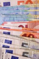 Close up of numerous euro banknotes lying on top of each other. photo