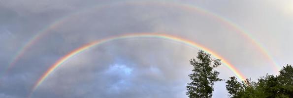 Stunning natural double rainbows plus supernumerary bows seen at a lake in northern germany photo