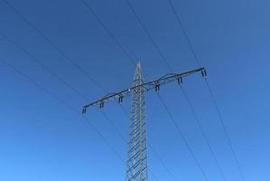 View of very large electricity pylons with high voltage cables from a moving car. photo