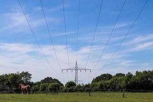 View of very large electricity pylons with high voltage cables from a moving car. photo