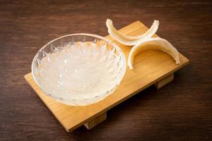 Edible bird's nest soup in glass bowl photo