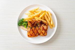 grilled chicken steak with potato chips or french fries photo