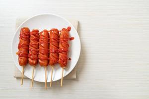 fried sausage skewer with ketchup photo