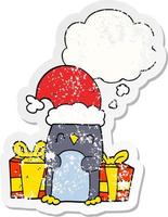 cute christmas penguin and thought bubble as a distressed worn sticker vector