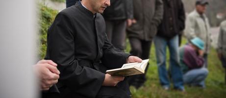 lectura del libro sagrado del corán por el imán en el funeral islámico foto