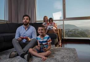 Happy family playing a video game photo