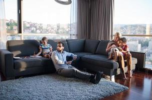 Happy Young Family Playing Together on sofa photo