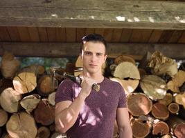 young man with an ax on his shoulder photo