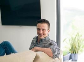 man on sofa using tablet computer photo