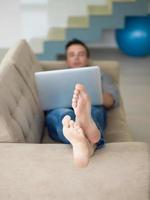 Man using laptop in living room photo