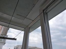 Installed metal-plastic windows on the balcony of a residential building photo