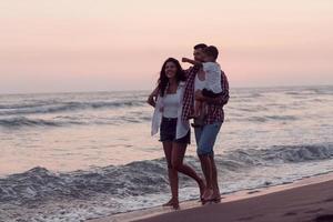 Happy young family have fun and live healthy lifestyle on beach. Selective focus photo