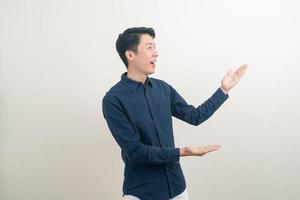 Asian man with hand pointing or presenting on white background photo