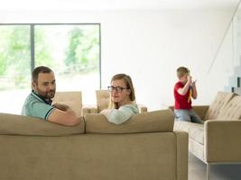 family with little boy enjoys in the modern living room photo