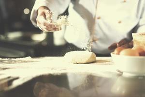 chef hands preparing dough for pizza photo