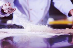 chef hands preparing dough for pizza photo