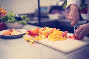 Chef cutting fresh and delicious vegetables photo