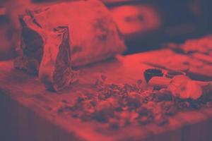 Juicy slice of raw steak on wooden table photo