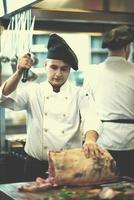 chef cutting big piece of beef photo