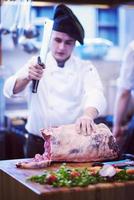 chef cutting big piece of beef photo