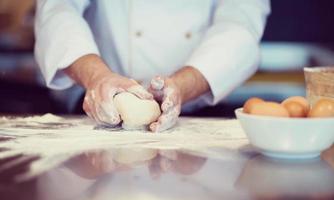 chef hands preparing dough for pizza photo