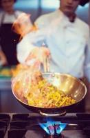 Chef doing flambe on food photo