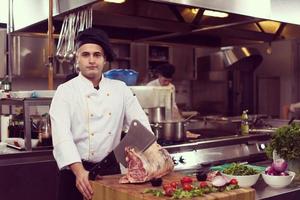 chef cutting big piece of beef photo