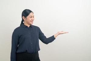 Asian woman with hand presenting on wall photo