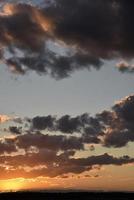 Explosive juicy red and blue evening sunset. Beautiful sunset landscape with colorful clouds. photo