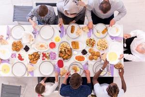 vista superior de la familia musulmana multiétnica moderna que tiene una fiesta de ramadán foto