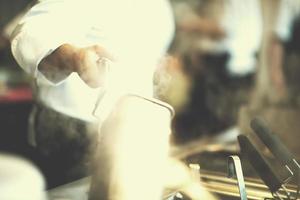 chef preparing food, frying in deep fryer photo