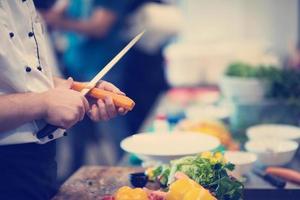 chef hands cutting carrots photo