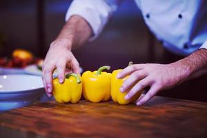 chef holding fresh peppers photo