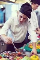 Chef finishing steak meat plate photo