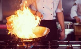 Chef doing flambe on food photo