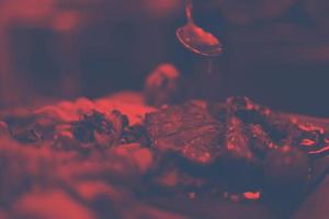 Chef hand finishing steak meat plate photo