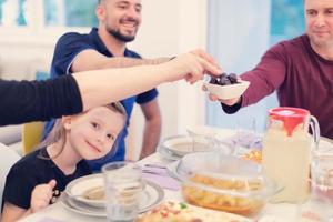 Eid Mubarak islamic family have Iftar dinner during Ramadan fest photo