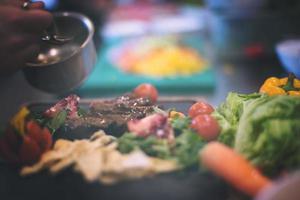 Chef hand finishing steak meat plate photo