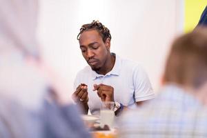 black man enjoying iftar dinner with family photo