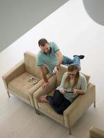 couple relaxing at  home with tablet computers photo