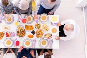 top view of modern multiethnic muslim family waiting for the beginning of iftar dinner photo